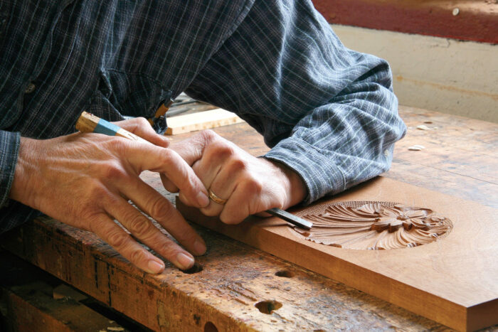 Hands carving intricate details